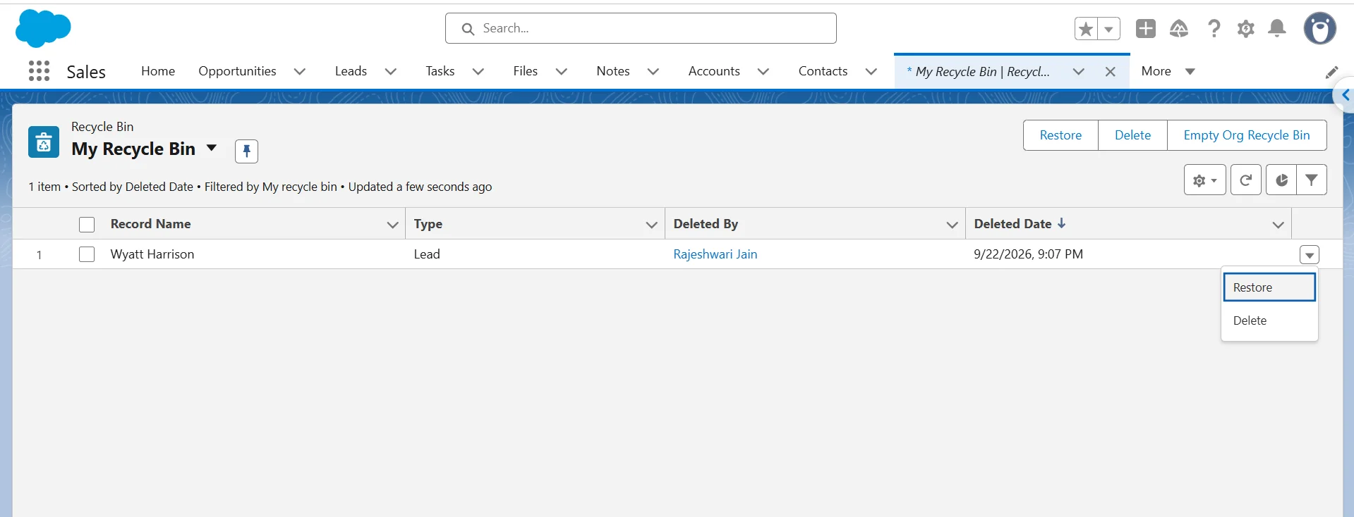 Salesforce Recycle Bin list view with a deleted Lead record and the Restore option selected.