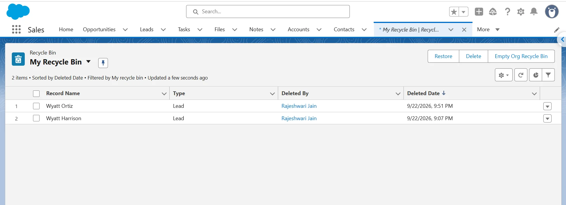 Salesforce Recycle Bin list view showing two deleted Lead records with the Deleted By column visible.